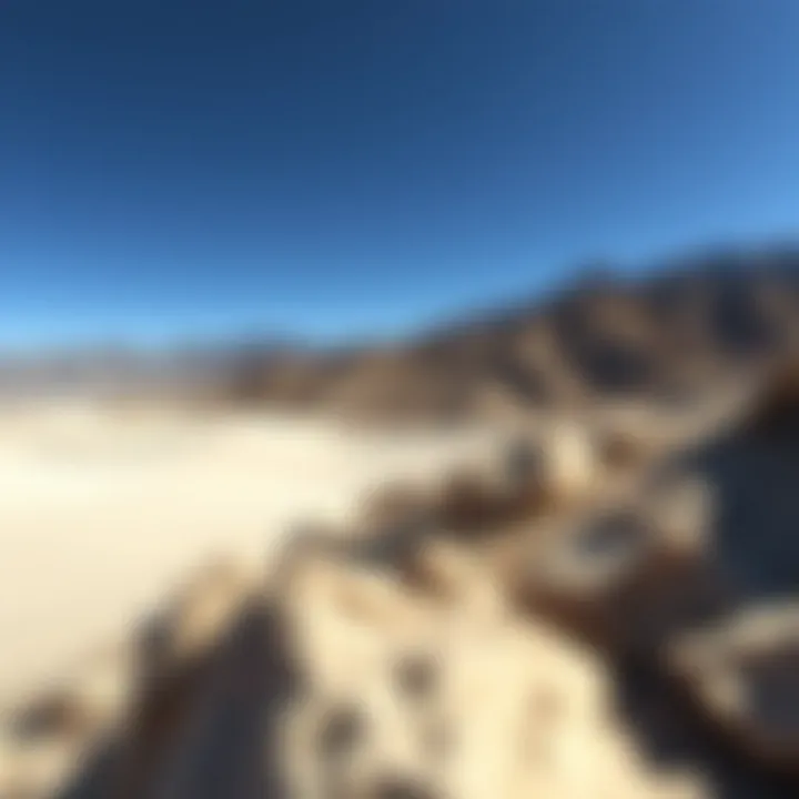 Scenic Desert Landscape Around Death Valley National Park Desert landscape with rocky hills and sand dunes near Death Valley National Park under a clear blue sky